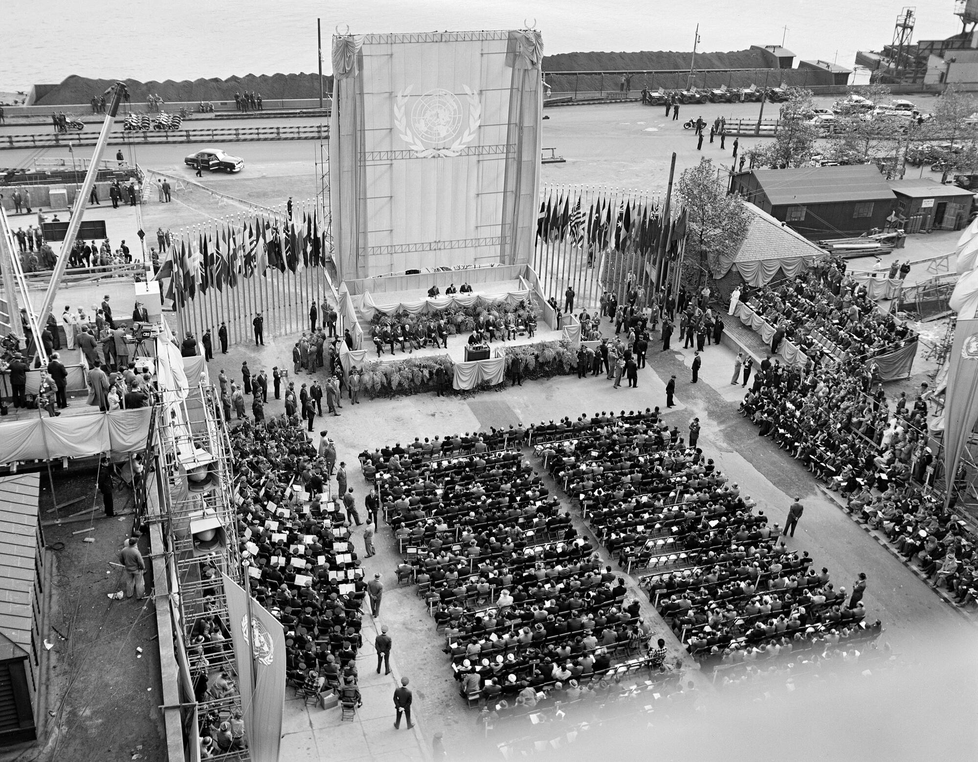 The cornerstone of the United Nations Permanent Headquarters, was laid on United Nations Day - 24 October - at a special open-air General Assembly meeting held on the site of the Headquarters building in Manhattan, New York. The ceremony, marking the Fourth Anniversary of the United Nations, was attended by President Harry S. Truman who was the principal speaker. Secretary-General Trygve Lie deposited in the stone copies of the United Nations Charter and the Universal Declaration of Human Rights.
General view of ceremony.