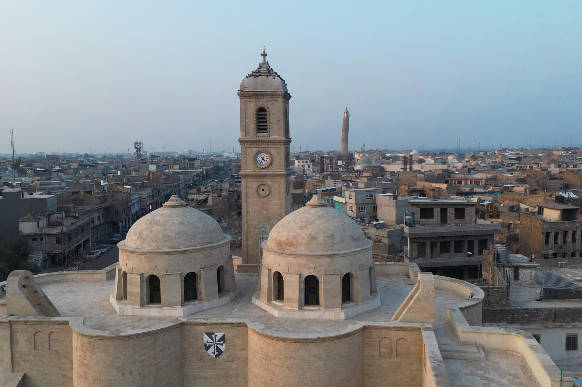 Mohamed Al Hassan (not pictured), Special Representative of the Secretary-General for Iraq and Head of the United Nations Assistance Mission for Iraq (UNAMI), attended the opening of the Grand Nuri Mosque and Al-Tahra Church in Mosul, Iraq, in the presence of Mohammed Shia` Al-Sudani, Prime Minister of the Republic of Iraq, as well as Noura bint Mohammed Al Kaabi, Minister of State at the Ministry of Foreign Affairs of the United Arab Emirates. 

"As we celebrate the rehabilitation of this mosque and its neighbor Al-Tahra Church, we are not celebrating the stones that have been rebuilt, but we are celebrating the revival of the Iraqi spirit. It is the symbol for the return of life, a mark of rejection of extremism, and the restoration of the values of co-existence that have been and remain a beacon of this country. I say this publicly: Mosul has returned and will return, and I call for the lifting of restrictions on Mosul and its people," said Mr. Al Hassan at the ceremony that celebrated the results of UNESCO’s reconstruction work under its Revive the Spirit of Mosul initiative, symbolizing a collective triumph of resilience, coexistence, and global solidarity.

A view of Mosul with the Al-Tahra Church in the foreground.