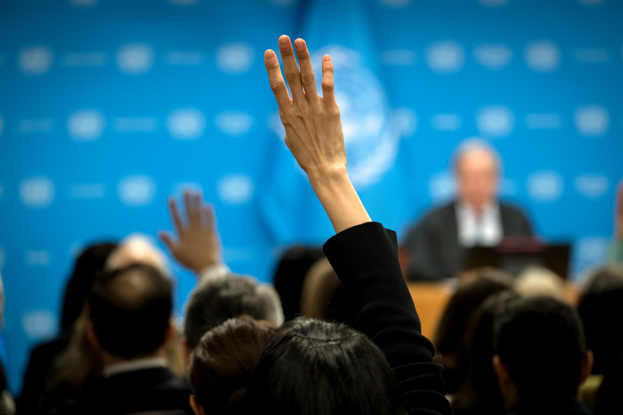 Secretary-General António Guterres (in the background) briefs reporters on his priorities for 2026.

"As we begin this year, we are determined to choose actions that generate concrete and positive reactions – as called for in the Pact for the Future. Reactions of peace, of justice, of responsibility, and of progress in our troubled times," said the Secretary-General.