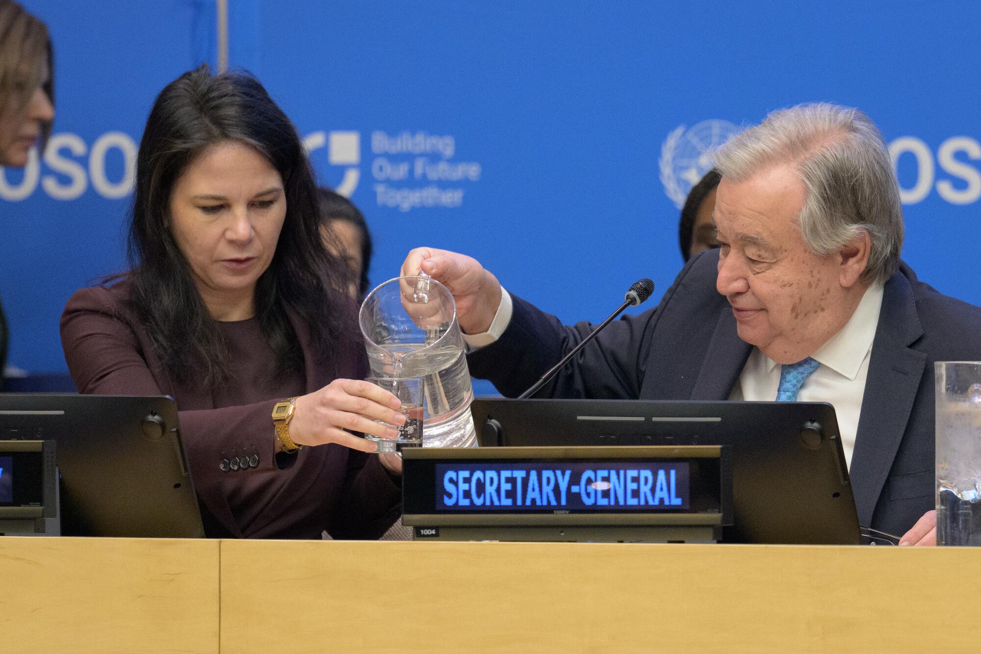Secretary-General António Guterres (right) pours water in a glass for Annalena Baerbock, President of the eightieth session of the United Nations General Assembly, during the special meeting on the commemoration of the eightieth anniversary of the Economic and Social Council entitled “ECOSOC80: A Turning Point for Multilateralism”.